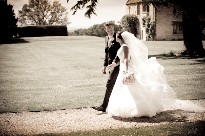 Professional colour photograph of bride and groom kissing in spring